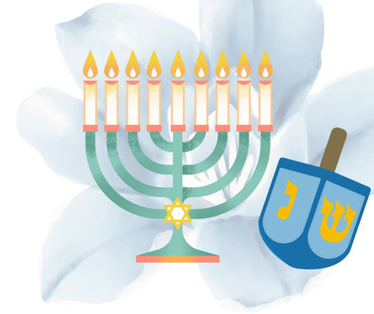 Hanukkah menorah and blue dreidel with a blue flower background