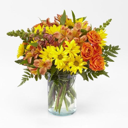Glowing and gorgeous. Bring harvest colors into the home with an arrangement made with the freshest blooms. standard size