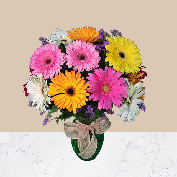 This bouquet includes an assortment of 18 Stems of Gerbera Daisies, mixed colors and a clear glass vase.