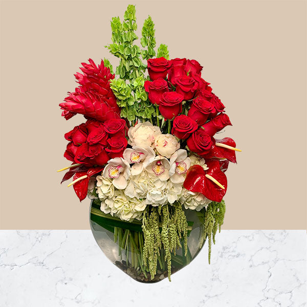  Stunning ginger and bells of Ireland, stand tall behind lush red roses, anthurium, and hydrangea. 