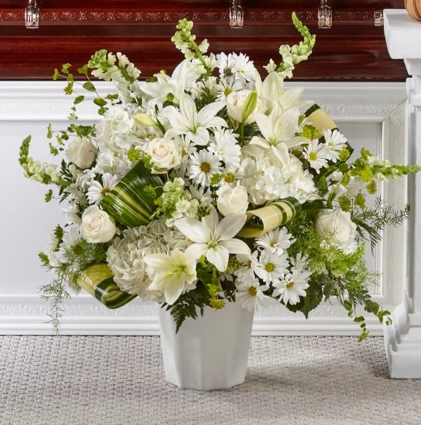 Our Thoughts of Tranquility Floor Basket is handcrafted by our designers with ivory roses and white hydrangea, snapdragons and lilies to show how much you care. 