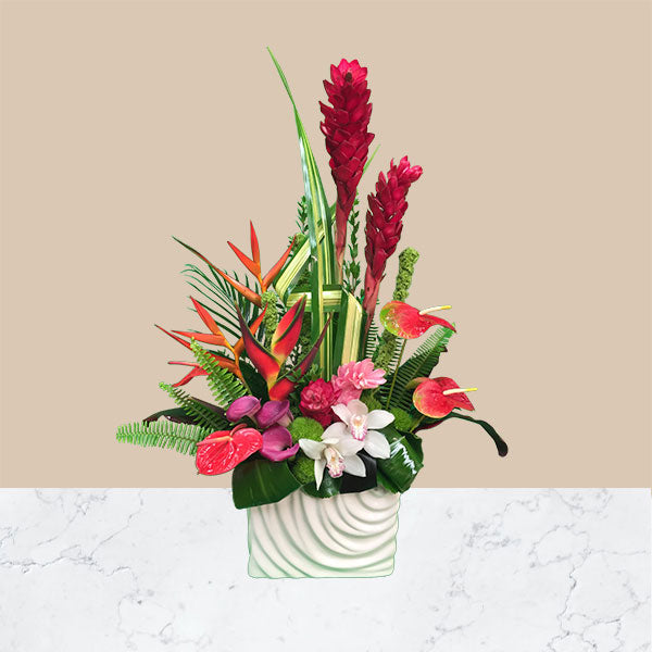  Eye-catching red ginger stalks command attention, as well as anthurium, orchid blooms, birds of paradise and tropical foliage.
