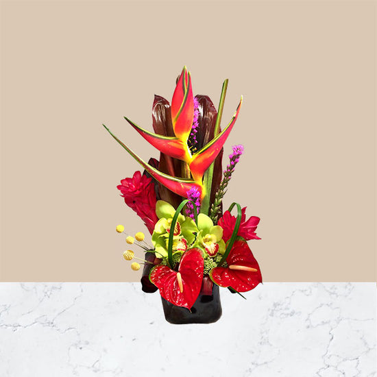 A contemporary design and combination of red Hawaiian ginger, striking heliconia, bright red anthuriums, cymbidium blooms and tropical foliage.
