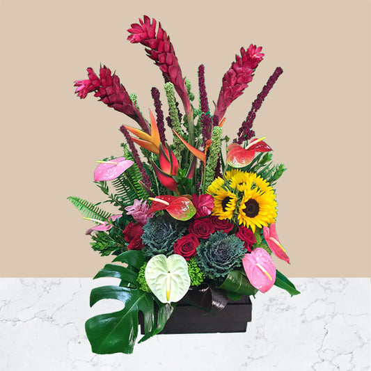  This exotic tropical flower bouquet  includes striking red ginger, bird of paradise, anthuriums, bold sunflowers. Red ginger will catch their attention, as will the assortment of birds of paradise, heliconia and anthuriums