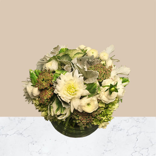 A luxurious design of white tones and natural greens in a bubble bowl vase.